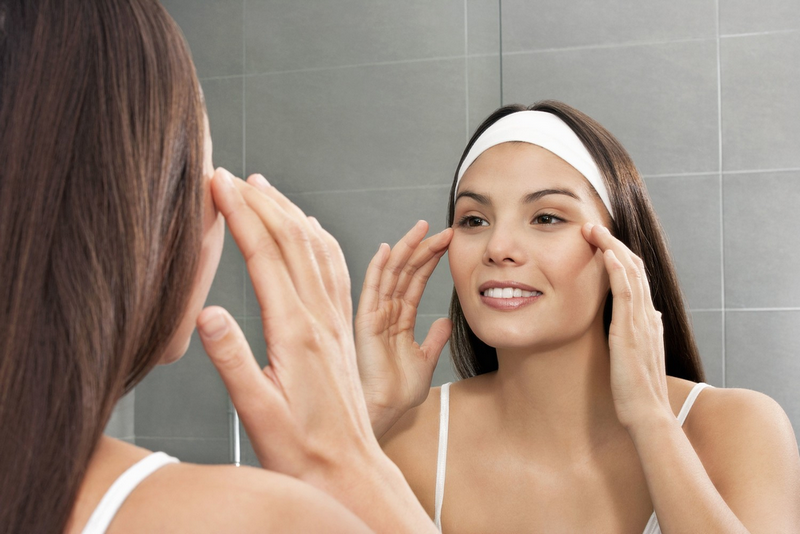 Facial massage technique: gently tapping fingers around the eyes to reduce puffiness and dark circles"